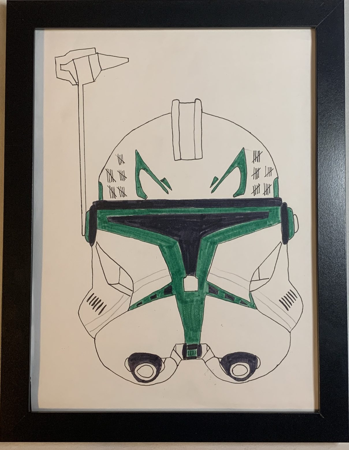 Framed ink and marker drawing of a clone trooper helmet with green markings and tally marks