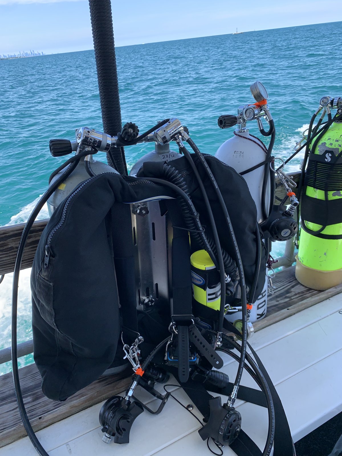 Dive tanks staged on a boat deck over Lake Michigan